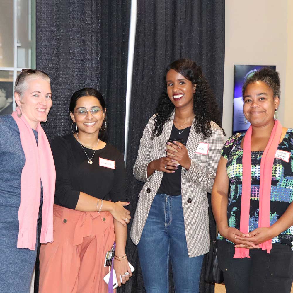 Four women together at a conference