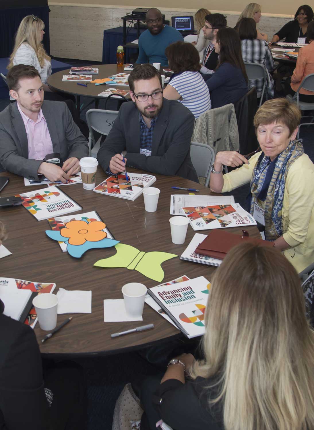 A diverse group of people at a table during a conference