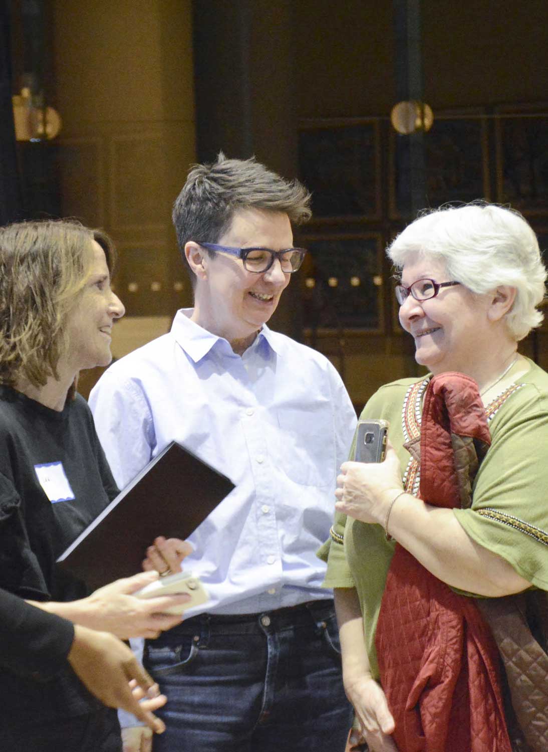 Three people talking at a conference